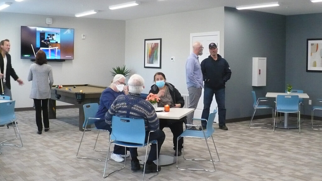 Guests gather in the community room at the Empire Luxury Living apartment building in Silvis.