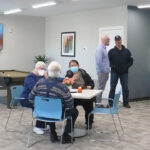 Guests gather in the community room at the Empire Luxury Living apartment building in Silvis.