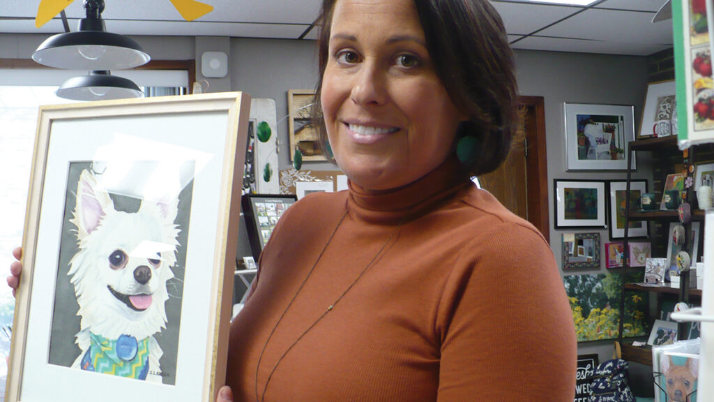 Sharon Larson shows one of her works of art – a portrait of a dog.