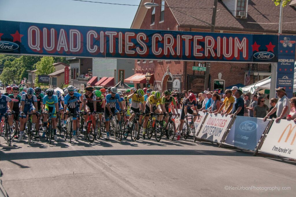 Racers crowd the starting line in this undated photo from a recent Kwik Star Criterium. This year is the 55th running of the Quad Cities race on Memorial Day, May 31. CREDIT VISIT QUAD CITIES