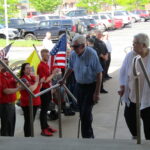 A veteran and his wife arrive at the pre-flight dinner, held at Bettendorf’s Waterfront Convention Center, for veterans going on the next Honor Flight. CREDIT DAVE THOMPSON