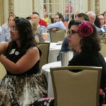 Downtown stakeholders and supporters listen to the Downtown Davenport Partnership’s annual meeting presentation Tuesday, June 28.