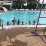 Young people enjoy a swim at the Splash Landing Family Aquatic Center in Bettendorf. The public swimming pool has now been closed for the summer because of deteriorating paint in the pool that is causing safety concerns.