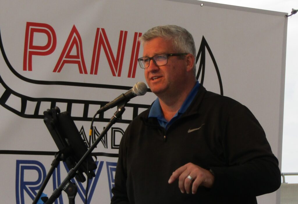 Ryan Jantzi, executive director of the Downtown Bettendorf Organization, talks to a crowd of people at the Be Downtown celebration in June.