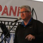 Ryan Jantzi, executive director of the Downtown Bettendorf Organization, talks to a crowd of people at the Be Downtown celebration in June.
