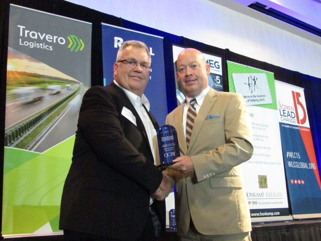 Dave Larson, left, business administrator for the Revive At The Group Medical Spa, receives the QCBJ’s award for the Fastest Growing Company in the region from John Lohman, Corridor Media Group publisher. A total of 15 companies were recognized at the reception on Tuesday, Aug. 9, at Bally's Quad Cities in Rock Island.