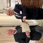 Rob Cain, right, the president of the LeClaire Chamber of Commerce, presents LeClaire Mayor Dennis Gerard with the Edward B. deSilva Award on Saturday, Jan. 28.