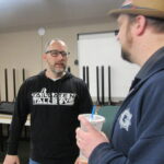 Clinton Mayor Scott Maddasion, left, discusses the Tailgates N’ Tallboys Music Festival during a meeting Friday, March 31, at the Grow Clinton office.