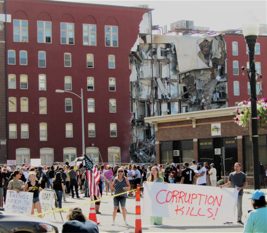 Protestors gathered Tuesday morning, May 30, outside of Davenport City Hall near the partially collapsed building at 324 Main St.