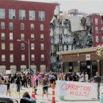 Protestors gathered Tuesday morning, May 30, outside of Davenport City Hall near the partially collapsed building at 324 Main St.