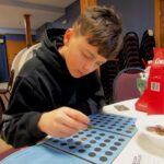 Caden Kahl, 11, sorts old pennies during a recent coin show in Muscatine, Iowa. CREDIT DAVE THOMPSON