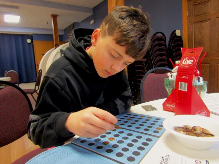 Caden Kahl, 11, sorts old pennies during a recent coin show in Muscatine, Iowa. CREDIT DAVE THOMPSON