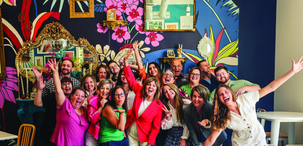 The United Way Quad Cities staff show their fun side surrounding President and CEO Rene Gellerman (center).