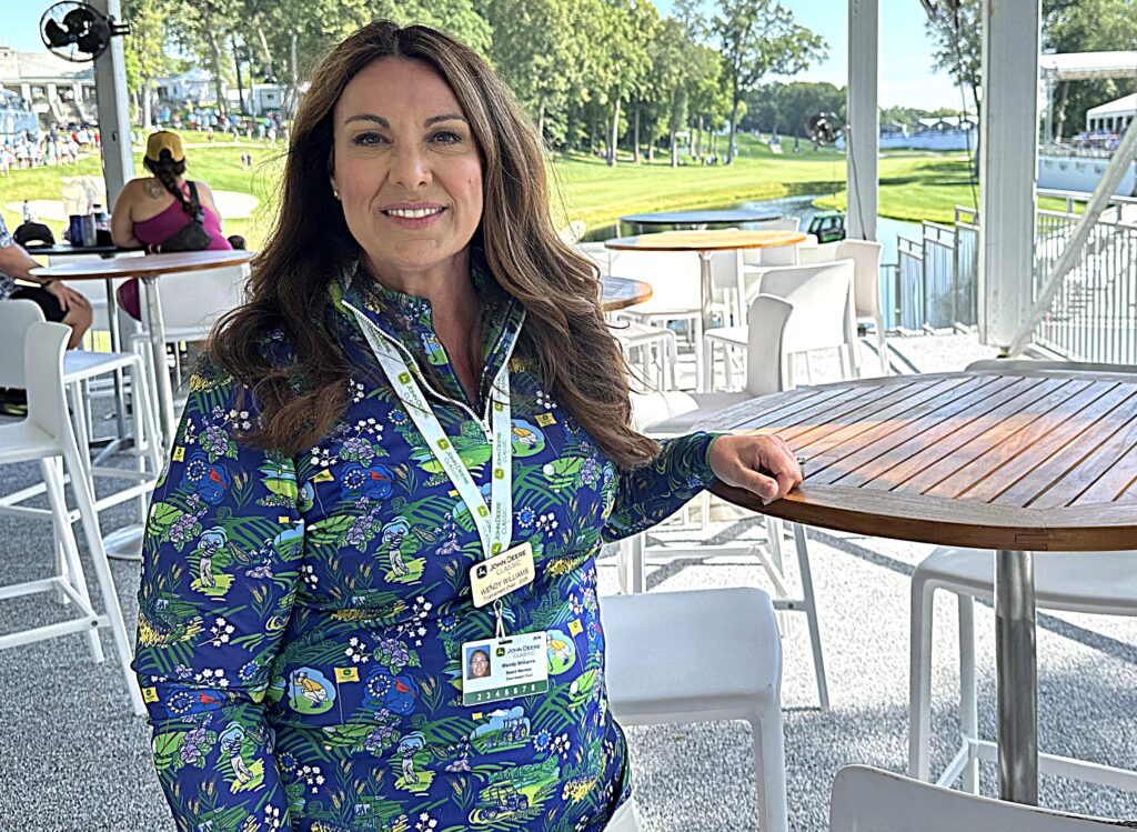 Wendy Williams, the 2026 John Deere Classic chair, poses in title sponsor John Deere’s hospitality suite. The additional outdoor area overlooks the 18th green, providing more space for the company and its customers, dealers and other guests. CREDIT JENNIFER DEWITT
