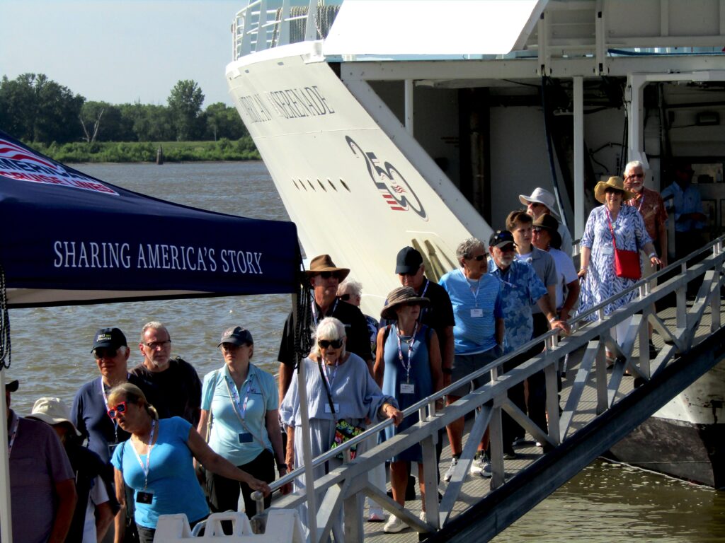 Passengers disembark from the American Serenade river cruise ship on the Muscatine riverfront on Monday morning, June 29. Around 155 people from the ship spent the morning in Muscatine.